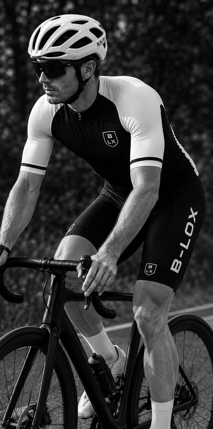 Rider in B-LOX kit on a road bike at dusk